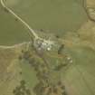 Oblique aerial view centred on the farmhouse with the farmsteading adjacent, taken from the S.