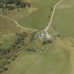 Oblique aerial view centred on the farmhouse with the farmsteading adjacent, taken from the E.