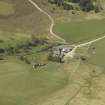 Oblique aerial view centred on the farmhouse with the farmsteading adjacent, taken from the E.