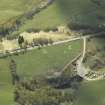 Oblique aerial view centred on the remains of the clearance cairns with the limekiln adjacent, taken from the NE.