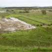 View.  Concrete base of Cordite loading station with platform and course of tramway to right, from SW.