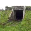 View.  Entrance to magazine showing brick abutments and metal  identification board from SW.