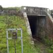 View.  Entrance to magazine showing brick abutments andmetal  identification board from W.