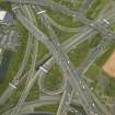 Oblique aerial view centred on the motorway interchange, taken from the SE.