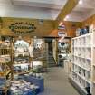 Interior view of ground floor of J Donald & Co, Bristo Place, Edinburgh. Front shop (S) rear area, showing modern shop fittings and display cabinets.