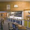 Interior. Ground floor. Back shop showing modern shop fittings and display cabinets and panelled archway.