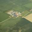 Oblique aerial view centred on the farmhouse and the farmsteading, taken from the SE.