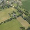 Oblique aerial view centred on the country house, garden and stables with the dovecots adjacent, taken from the NE.