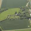 Oblique aerial view centred on the remains of the castle, stable and walled garden, taken from the NW.