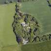 Oblique aerial view centred on the country house, conservatory, dovecot and farmsteading, taken from the WSW.