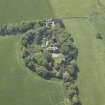 Oblique aerial view centred on the country house, conservatory, dovecot and farmsteading, taken from the E.
