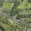 Oblique aerial view centred on the gate-lodge, gate piers and hotel, taken from the NW.