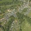 Oblique aerial view centred on the gate-lodge, gate piers and hotel, taken from the SW.