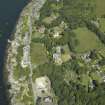 General oblique aerial view centred on the town and country house, from the SE.