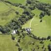 Oblique aerial view centred on the house, taken from the WNW.