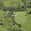 Oblique aerial view centred on the house, taken from the W.