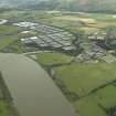 Oblique aerial view.  Tullibody, Cambus Distillery and bonded warehouses from SE.