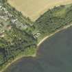 Oblique aerial view centred on the remains of the church, watch house and burial ground, taken from the SW.