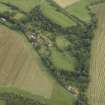 Oblique aerial view centred on the country house, cottage and walled garden, taken from the NW.