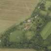 Oblique aerial view centred on the country house, cottage and walled garden, taken from the SW.