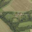 Oblique aerial view centred on the country house, cottage and walled garden, taken from the SSW.