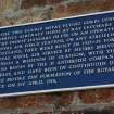 Detail.  Plaque on NE aircraft hangar regarding building date and history of coupled sheds.