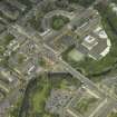 Oblique aerial view centred on the academy  and road bridge, taken from the SSE.