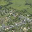 General oblique aerial view of the village centred on the churches, burial-ground and manse, taken from the S.