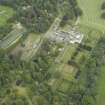 Oblique aerial view centred on the country house, walled garden, gardens and terraces, taken from the WSW.