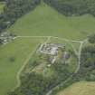 Oblique aerial view centred on the farmsteading, stallion house and gate-lodge, taken from the E.