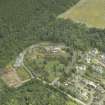 Oblique aerial view centred on the house and gate-lodge, taken from the WNW.