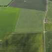 Oblique aerial view centred on the cropmarks of the unenclosed settlement, pits and pit-alignment, taken from the ENE.