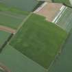 Oblique aerial view centred on the cropmarks of the palisaded enclosure, taken from the ESE.