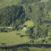 General oblique aerial view centred on the country house and the suspension bridge, taken from the SW.