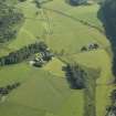 General oblique aerial view of the Kilmartin valley centred on the remains of the chambered cairn, standing stones, stone setting and cairns and the farmstead and school, taken from the S.