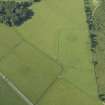 Oblique aerial view centred on the remains of the standing stones, henge and barrow, taken from the NE.