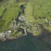 General oblique aerial view of the village centred on the quay and cottages, taken from the NE.