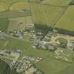 Oblique aerial view of the village centred on the school and church, taken from the S.