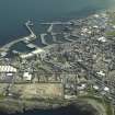 Oblique aerial view of Fraserburgh centred on the harbour, taken from the NW.