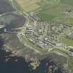 General oblique aerial view of the village centred on the harbour, taken from the NNW.