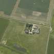 Oblique aerial view centred on the farmhouse and farmsteading, taken from the ENE.