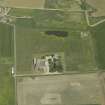 Oblique aerial view centred on the farmhouse and farmsteading, taken from the W.