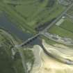 Oblique aerial view centred on the road bridge with the gate-lodge adjacent, taken from the NE.