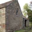 Building to SE of steading, S gable, view from SW showing the reused stonework.