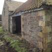 Building to SE of steading, S wall, view from SE shwoing shed door.