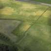 Oblique aerial view centred on the cropmarks of the settlement, taken from the SE.