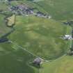 General oblique aerial view centred on the cropmarks of the possible souterrain and the rig with the village adjacent, taken from the NE.