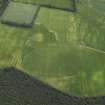 General oblique aerial view centred on the cropmarks of the rig and pits with the country house adjacent, taken from the WNW.