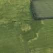 Oblique aerial view centred on the cropmarks of the rig and pits, taken from the WSW.