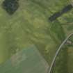 Oblique aerial view centred on the cropmarks of the ring-ditches and roundhouses, taken from the W.